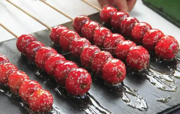 Sugar-coated Hawthorn candied hawthorn berries on a stick