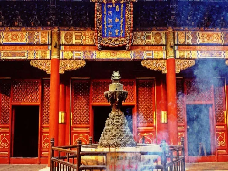 Lama Temple incense smoke rising before ornate red and gold hall facade