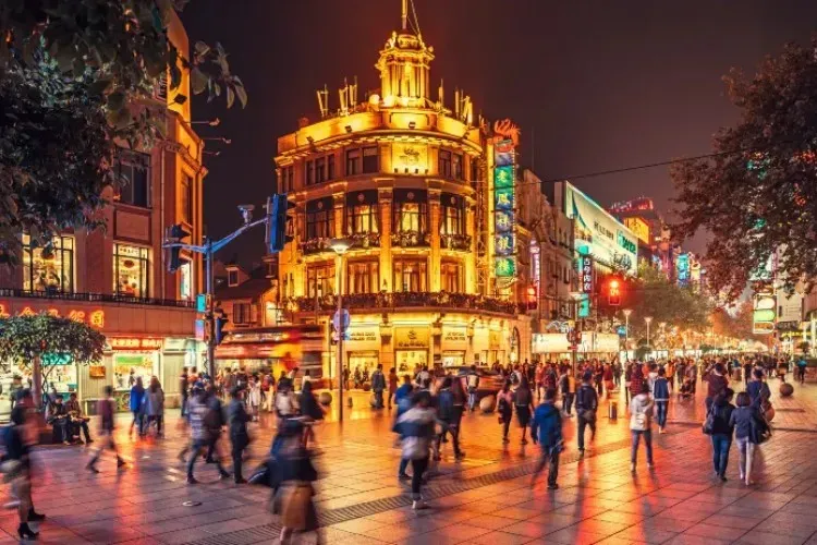 Nanjing Road pedestrian street at night with neon lights and crowds